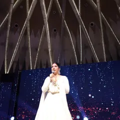 A low-angle shot capturing me against a starry backdrop at a Sangeet night. The right stage presence can make a great event feel truly epic and unforgettable.