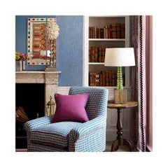 This cozy nook is a perfect example of how wallpaper and upholstery can work together to create a charming vibe. The mix of the houndstooth chair, textured wall, and patterned curtains is a beautiful exercise in layering.