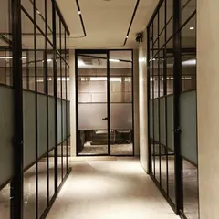 This corridor at the HLP site office demonstrates how lighting can define a path. A sleek, magnetic track lighting system follows the circulation route, providing functional light while creating a strong, directional design element that complements the modern glass partitions.