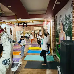 A wide shot of our shala during the International Yoga Day practice, with students of all ages participating.