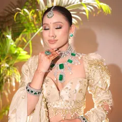 A close-up of the soft glam morning bridal makeup. I focused on creating luminous skin and defining her eyes, complemented by stunning emerald and diamond jewelry.