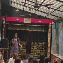 An interactive session with students at our puppet theater. A young participant takes the stage to share her thoughts, demonstrating the engaging and participatory nature of our educational programs.