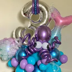 An intricate under-the-sea themed balloon sculpture for a 3rd birthday, featuring a large foil number and a detailed octopus figure.