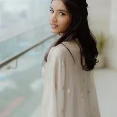 A beautiful shot of Moksha looking back. The natural light catches her dewy skin perfectly, showing off the fresh and clean makeup look.