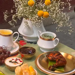 The non-vegetarian stars of our Eid feast. A perfectly grilled chicken leg, fresh jackfruit, and a variety of chutneys and dips, all beautifully arranged and ready to be enjoyed.