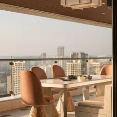 The dining area on the Gingham Dreams terrace, with modern swivel chairs and a Japanese-style lightbox, offering a sophisticated spot for al fresco meals.