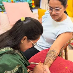 A candid moment of me applying a custom Ghibli-inspired design for a bride. I love bringing unique ideas to life.
