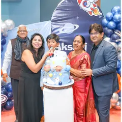The cake cutting is a moment for the whole family. Here, Akshaj is surrounded by his parents and grandparents for his space-themed birthday cake.