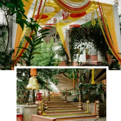 The entrance to a naming ceremony, beautifully decorated with yellow and orange drapes, marigold garlands, and traditional umbrellas.