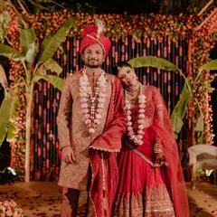 Embracing tradition with a modern flair. This couple wanted a vibrant, colorful wedding, so we designed a stunning backdrop using thousands of orange and red marigolds, complemented by banana leaf pillars for a rich, festive look.