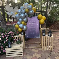 Welcome your guests in style with a personalized entrance sign. For this 40th birthday, we designed a custom welcome board and decorated it with a classy gold and silver balloon arrangement, lanterns, and wooden crates for a rustic yet elegant feel.