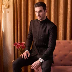 A portrait of modern royalty. The black bandhgala, with its restrained yet classy embroidery, is the perfect choice for a formal reception or sangeet. The fit is tailored to be sharp yet comfortable, allowing you to own the evening.