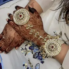 The dark henna stain provides a beautiful backdrop for festive hand jewellery.