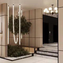 We love incorporating greenery and unique lighting into our designs. This corner of a lobby uses a custom light installation over a small plant bed to create a beautiful and unexpected visual moment.