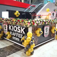 A full view of the brand-matched balloon decor for the Kiosk Kaffee launch. The combination of the large arch and smaller clusters created a cohesive and high-energy environment for their first day of business.