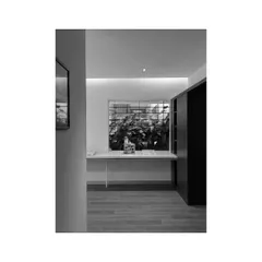 A view of a workspace in our studio, looking out towards an internal green courtyard. I believe in creating work environments that are connected to nature.