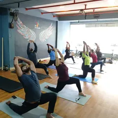 Our group yoga sessions are all about finding strength and alignment together. Here, we're moving through Anjaneyasana, a great pose for opening up the hips. Even in a group, we make sure everyone's form is on point.