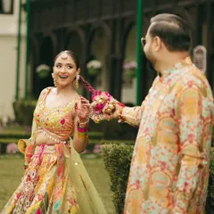 A fun, candid moment between the couple during the Haldi celebrations. Vasav's playful hairstyle and vibrant outfit are perfect for the happy occasion.