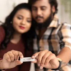 The moment it all became real. This close-up shot of the couple holding their positive pregnancy test is a powerful and emotional way to announce their journey.
