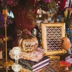 A close-up of the centerpiece, showing the intricate details of the mercury glass pumpkin, the miniature lamp, and the beautifully framed pattern.