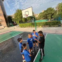 It's important to pause and talk strategy. In this huddle during a practice game, we are discussing on-court positioning and decision-making. This is how we build basketball IQ, ensuring players not only have the skills but also the intelligence to read the game.