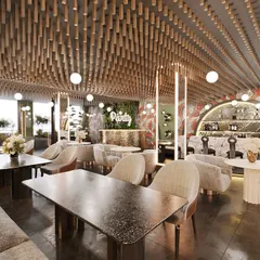 Another view of the Elation cafe, showing the party area with a green wall and custom bar. The design uses a mix of textures and lighting to create a warm and stylish atmosphere.