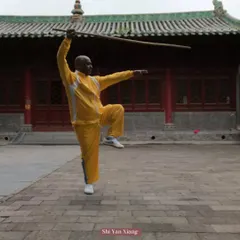 Pictured here during my training at the Shaolin Temple. This is a classic staff posture, which builds balance, strength, and coordination. The staff is a foundational weapon in Shaolin Kung Fu.