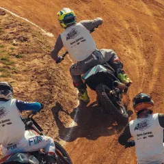 An overhead view of the intense, close-quarters racing at the Slide School Cup. Our riders are trained to be aggressive yet precise, even when battling for position on a challenging dirt track.