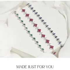 Three of my iconic bracelet designs laid out together. This image showcases the variety in my collection, from the Emerald Lotus to the Ruby Clover and the Sapphire Mirage.