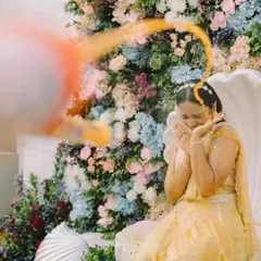 A dynamic action shot of the bride being playfully splashed with turmeric water during her Haldi ceremony. Her expression of surprise and joy is priceless.