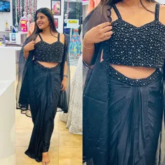 This black draped saree with a fully beaded blouse is a glamorous choice for any evening event. The modern silhouette gives the elegance of a saree with the comfort of a gown.