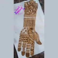 A full-hand design featuring peacock motifs, sketched on paper. This is a great way to plan out a complex bridal design.