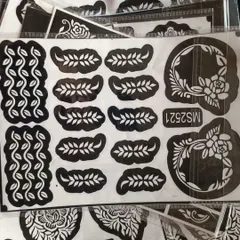 A stencil sheet with delicate vine and leaf patterns. These are perfect for creating borders or adding small details to your henna design.