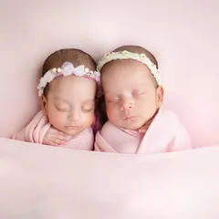To the most adorable duo. Tucked in together under a soft pink blanket, these twin girls look so peaceful and content.