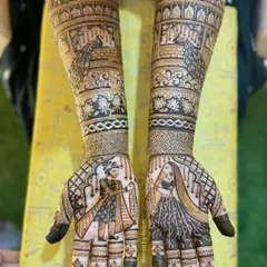 This is what I love to do most, weaving a couple's story into their bridal mehendi. This design features beautiful bride and groom portraits, capturing their likeness in henna, surrounded by traditional jharokha and peacock motifs for a truly royal wedding look.