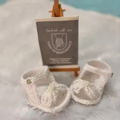 Perfect for warmer weather, these open-toed baby sandals are made from breathable cotton yarn and feature a sweet bow detail.