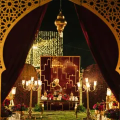 The entrance to a Sufi Sangeet, designed to feel like stepping into a royal, mystical courtyard. We used velvet drapes, intricate jaali arches, and warm candlelight to create an opulent and soulful atmosphere.