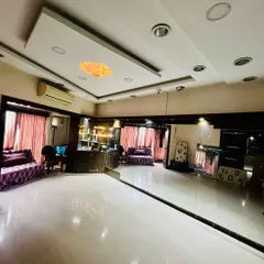 Another angle of the studio, showing the clean, reflective flooring and professional setup. This space is ideal for both group classes and private sessions.