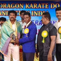 Presenting an award to a fellow master at a prestigious award and belt grading ceremony.