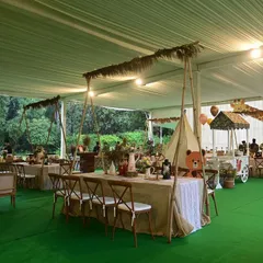 A wide view of a Boho Chic animal-themed party set up inside a weatherproof tent. The decor features natural textures, rustic furniture, and a soft, earthy colour palette for a calm and stylish celebration.