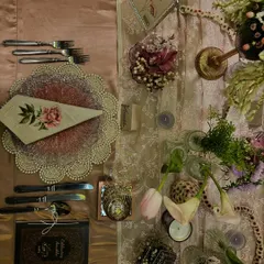 This tablescape for an intimate celebration layers textures and colors to create a rich, luxurious feel. Every element, from the cutlery to the candles and flowers, was chosen to contribute to an unforgettable dining experience.