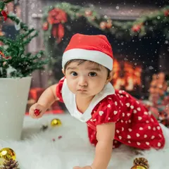 The crawling milestone captured during a Christmas mini-session. The determined look on her face as she reaches for an ornament is a precious memory.
