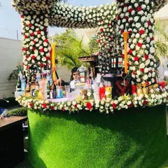 A closer look at the stunning floral bar I created for a wedding. The entire structure is covered in a dense arrangement of fresh flowers, providing a truly high-end and bespoke beverage station.