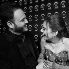 In the quiet moments between the celebrations, true feelings shine. This candid, black and white shot captures the pure, unscripted laughter that we live to document, proving that the most timeless memories are often the simplest.