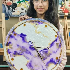 We love celebrating our students' success. Here is the talented artist with her finished resin art clock, a perfect example of the skills and confidence gained in our workshops.