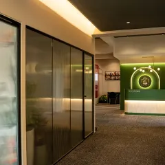A view from the hallway looking towards the reception desk. I used fluted glass panels for the office doors to provide privacy while still allowing light to filter through, maintaining a sense of openness.