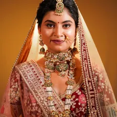 The glow on her face says it all. A beautiful portfolio shot showcasing a traditional bridal look with intricate jewellery.