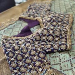 A deep purple velvet blouse with all-over floral jaal embroidery. The use of gold zardosi and light blue thread creates a stunning contrast and a truly royal look.