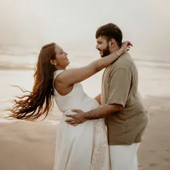 An outdoor maternity shoot on the beach is all about capturing pure, uninhibited joy. I love these moments of laughter and connection, where you can almost feel the sea breeze and the warmth of their love.