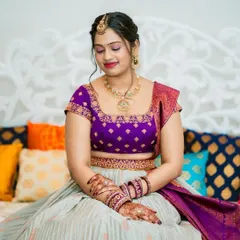 A stunning portrait of the bride, her intricate henna and beautiful jewelry perfectly complementing her custom lehenga.